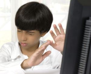Boy shocked at computer screen